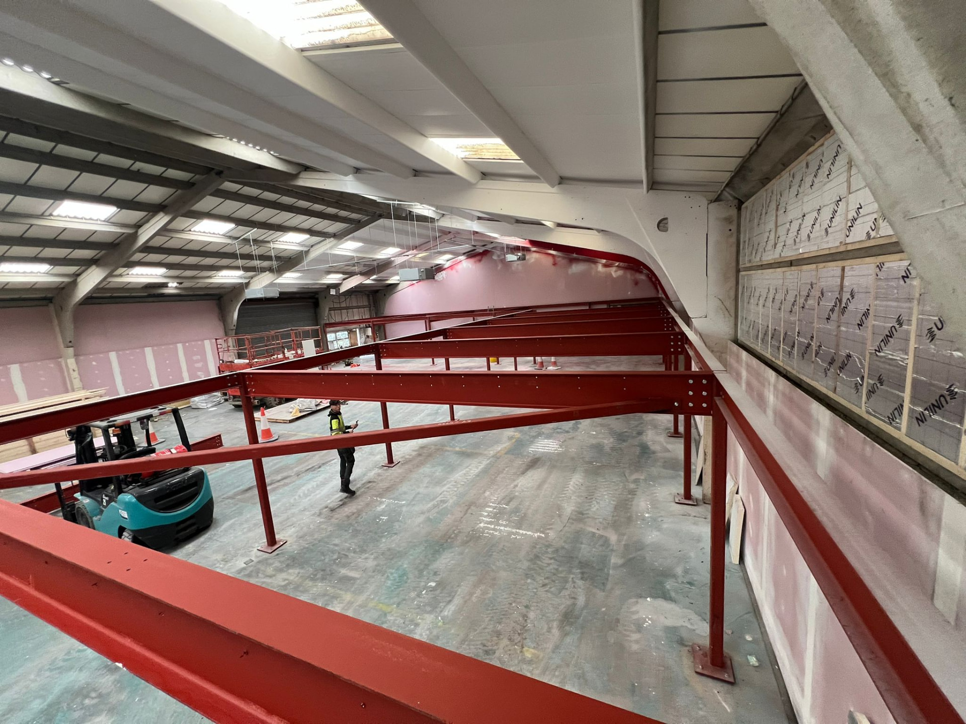 Red oxide steel frame for a new mezzanine floor inside an industrial unit